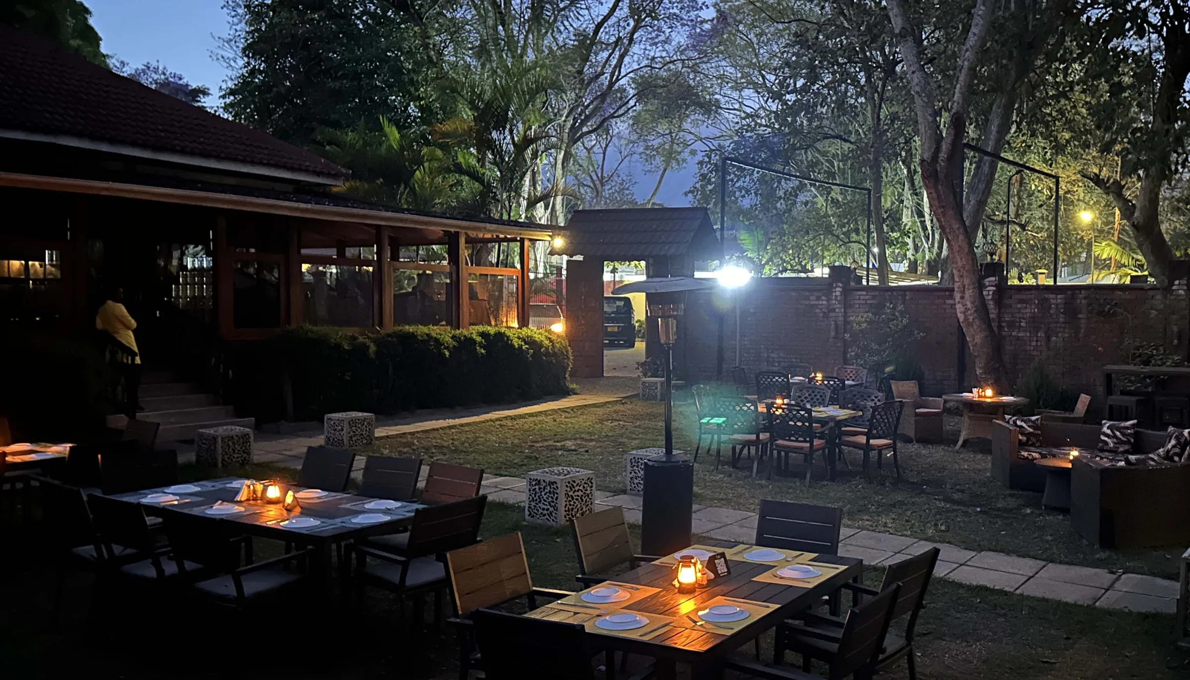 Candle-lit tables set out on Amber's garden terrace in the evening