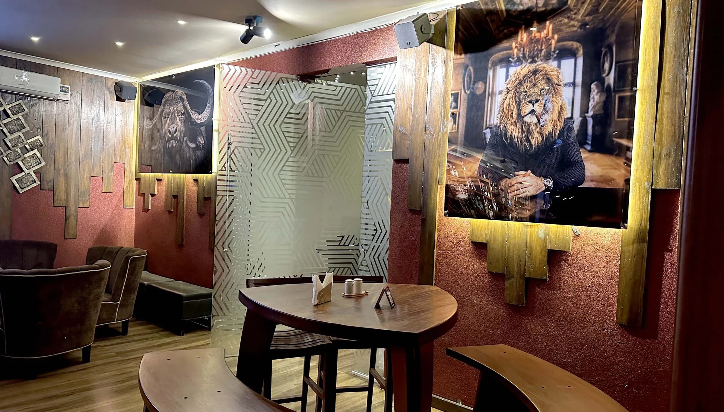 Amber's lounge, with warm wood panelling and a large lion portrait on the wall